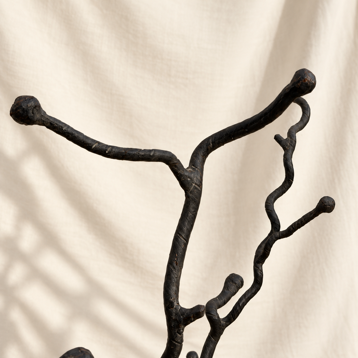 Detail of branching metal top on tree-form floor stand