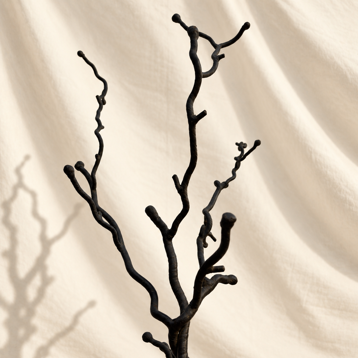 Dark metal tree-form floor stand with branching top and twisted trunk