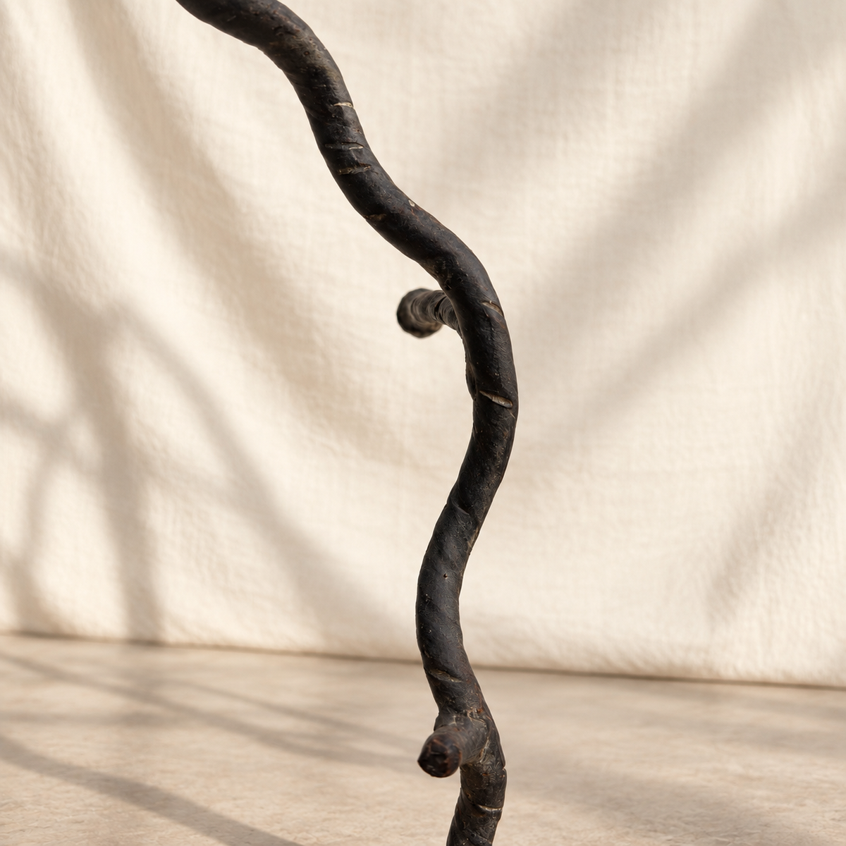 Side view of tree-form metal floor stand with organic branching silhouette