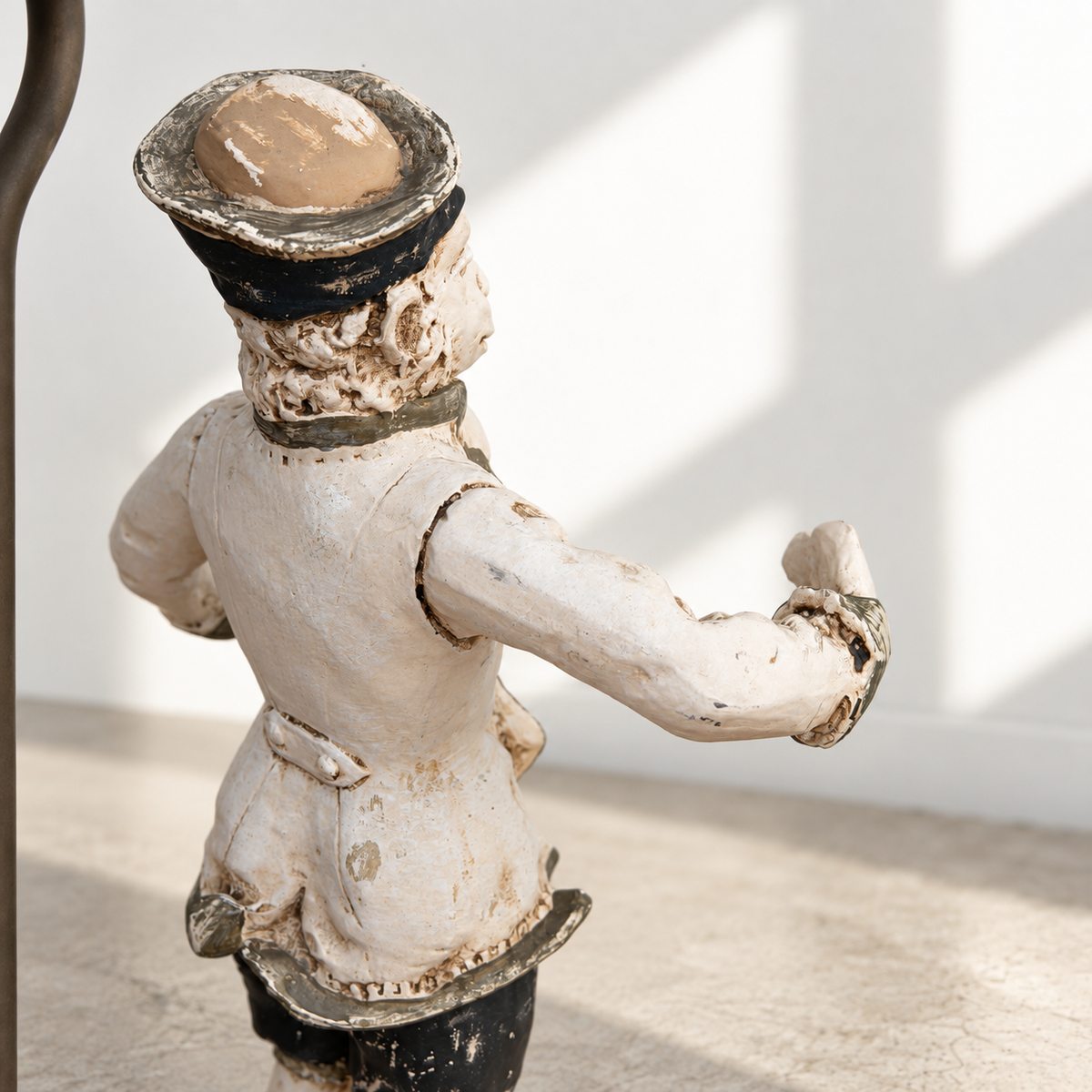 Close-up of painted monkey figure with black and gilt details