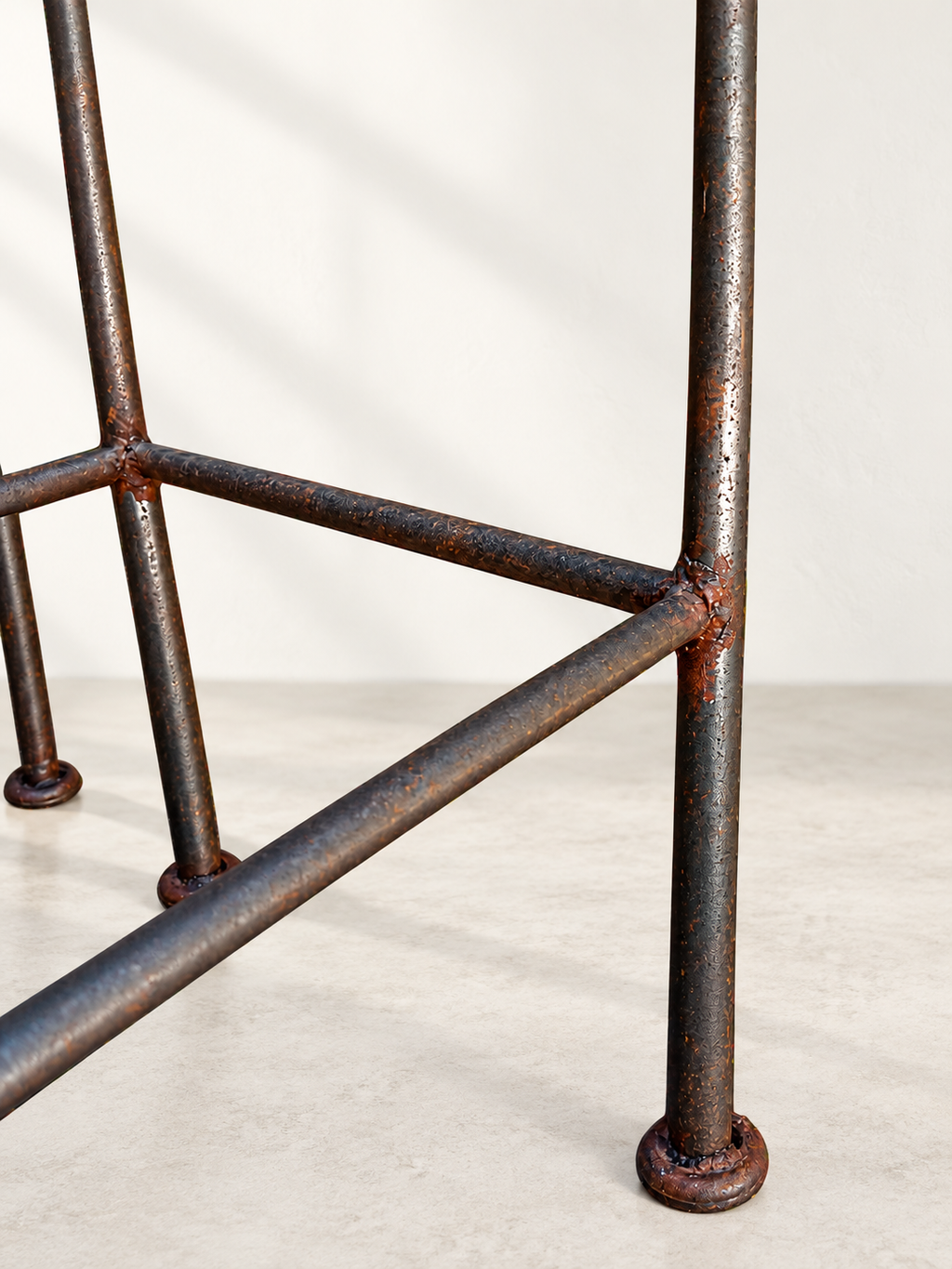 Tall open back on sculptural black iron bar stool