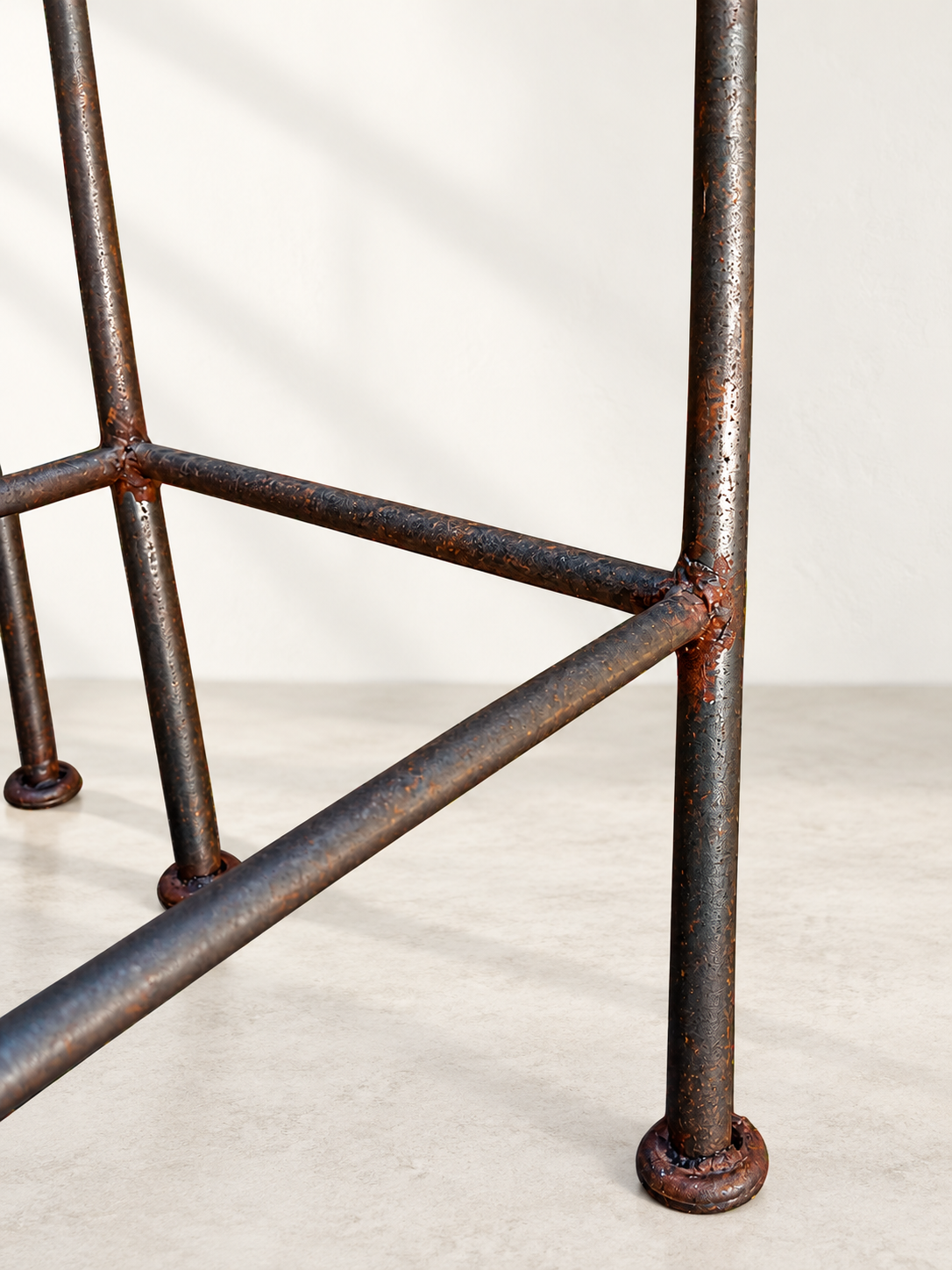 Tall open back on sculptural black iron bar stool