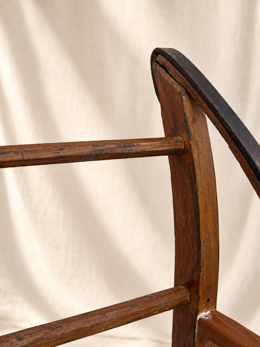 Detail of curled iron terminal on primitive wood sled