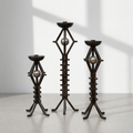 Set of three vintage wrought iron floor candlesticks with orb accents