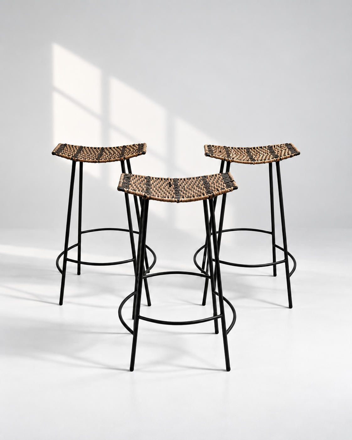Set of three Arthur Umanoff wicker and iron bar stools