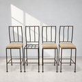Set of four sculptural wrought iron bar stools with tall open backs