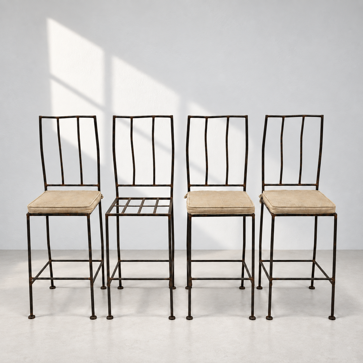 Set of four sculptural wrought iron bar stools with tall open backs