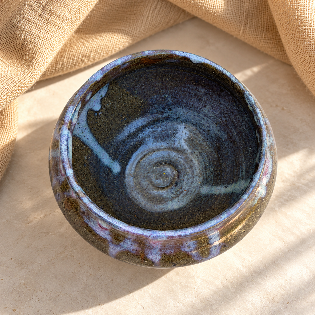 Interior of studio pottery bowl with layered multicolor glaze