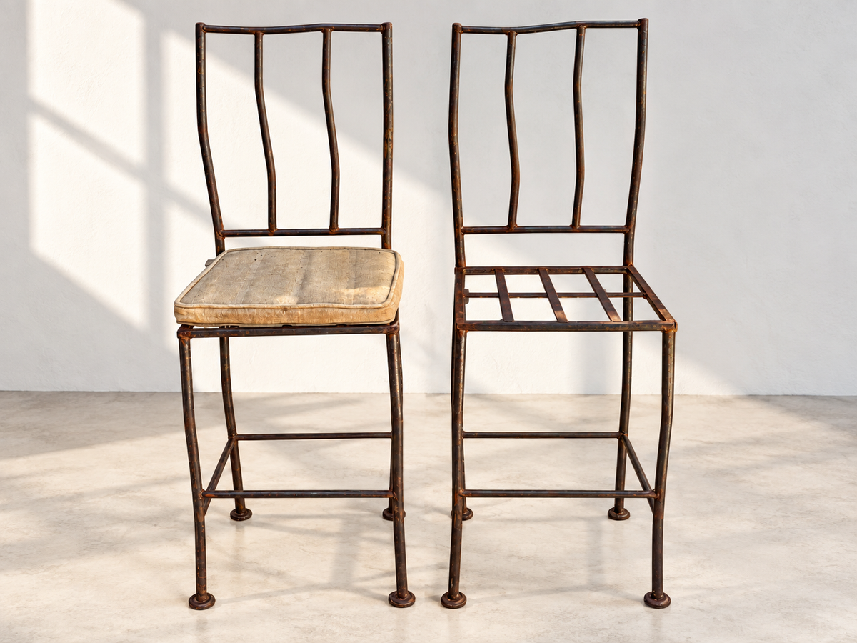 Four high-back wrought iron bar stools with gold-tone cushions