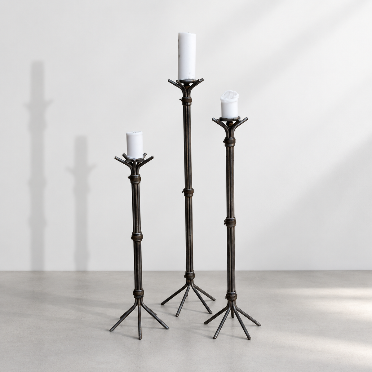 Set of three Brutalist iron floor pricket candlesticks in graduated heights