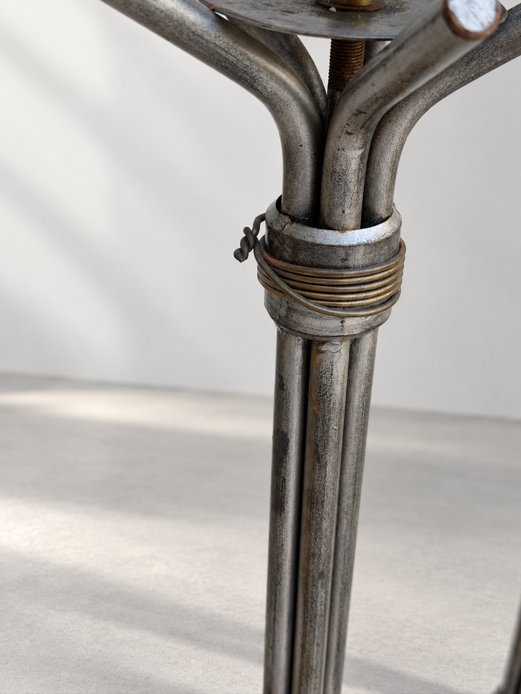 Close-up of pricket candle cup on Brutalist iron floor candlestick