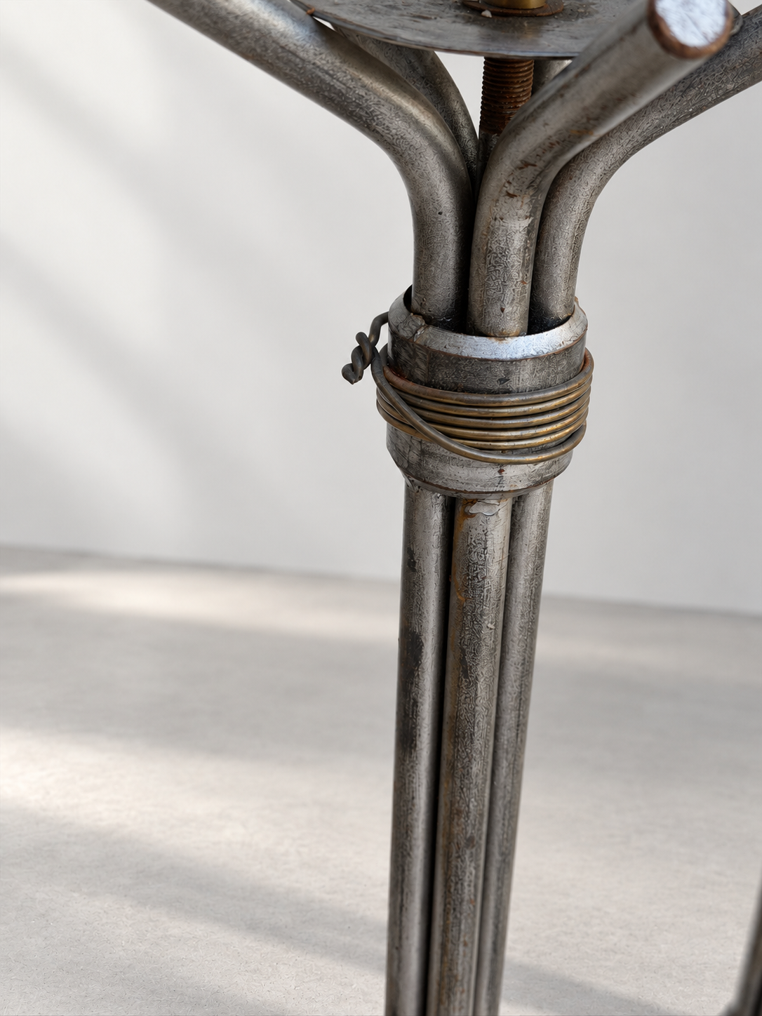 Close-up of pricket candle cup on Brutalist iron floor candlestick