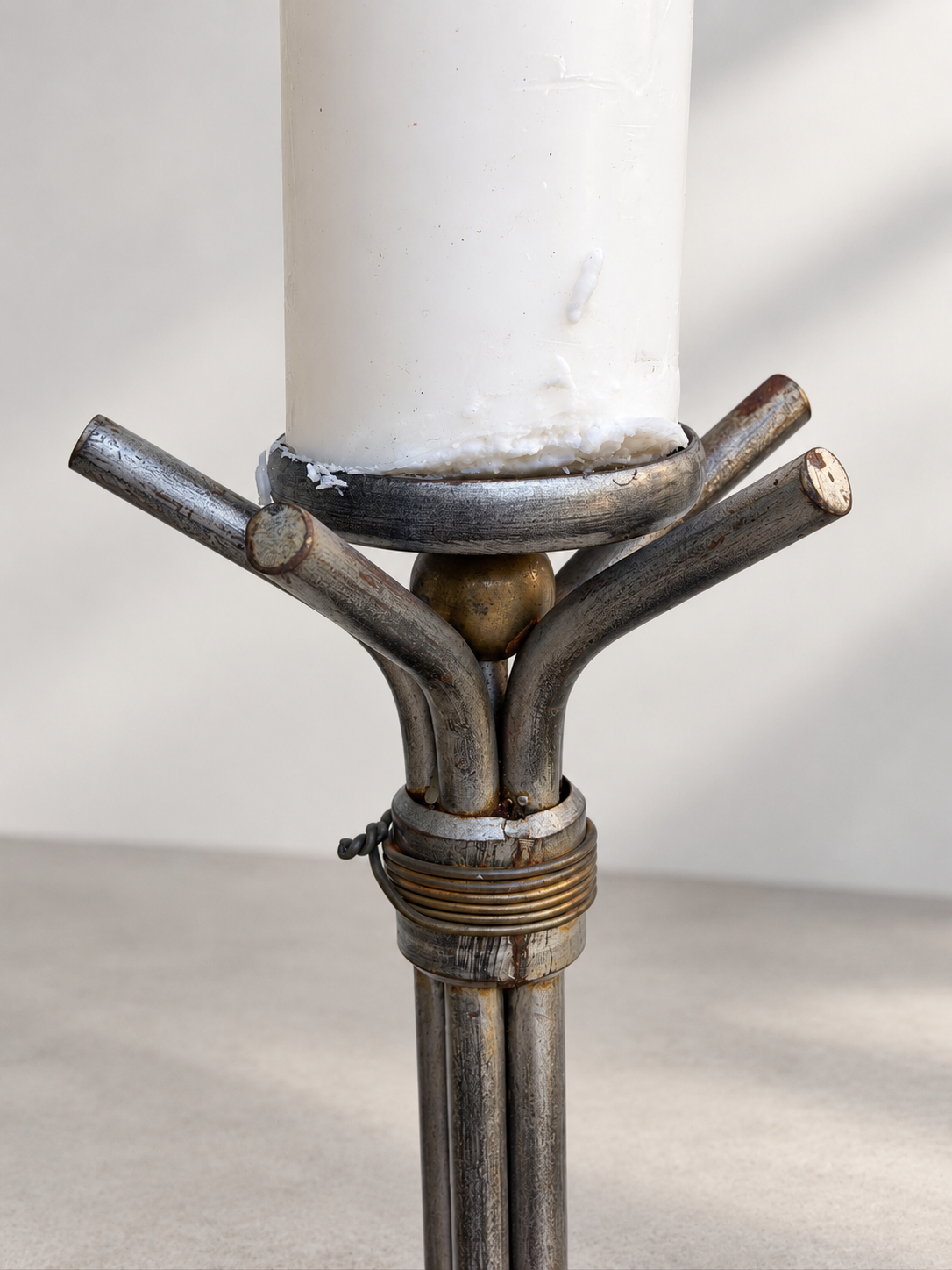 Brutalist-style floor candlesticks with dark iron finish and splayed bases