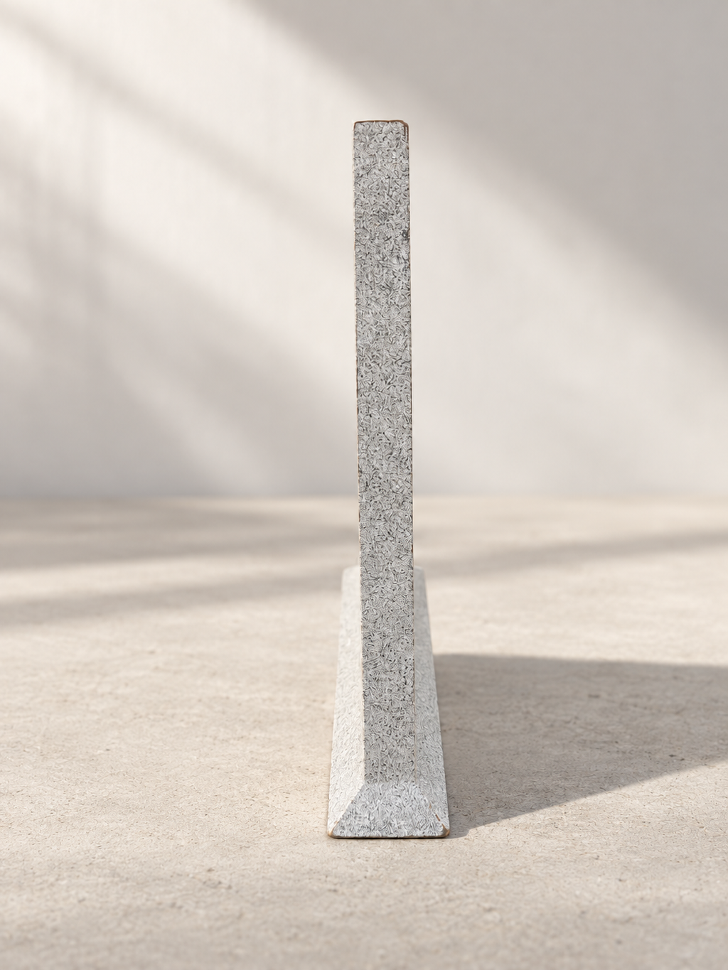 Side view of triangular table clock with speckled finish