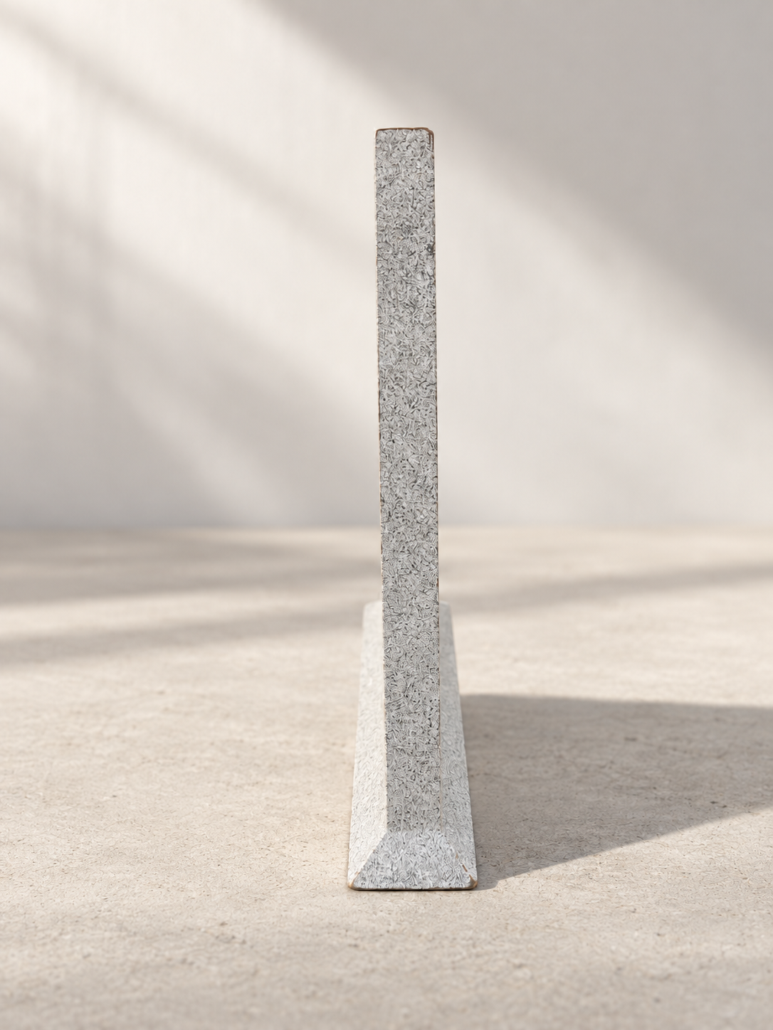Side view of triangular table clock with speckled finish