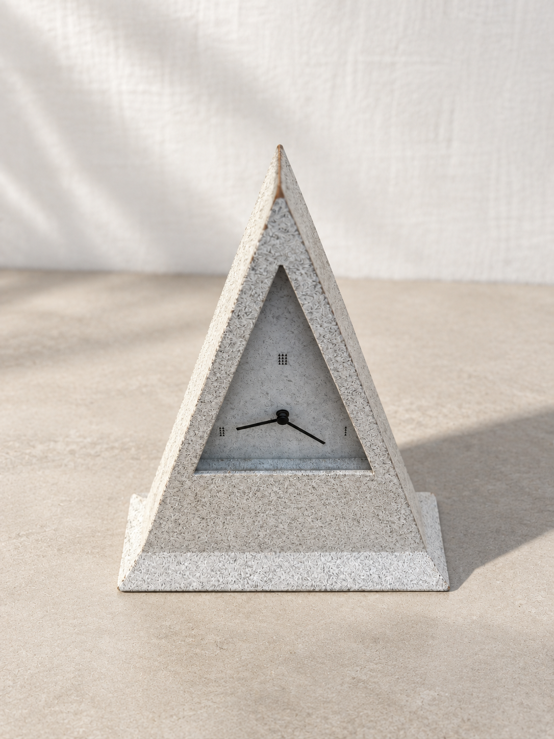 Close-up of speckled gray surface on postmodern table clock