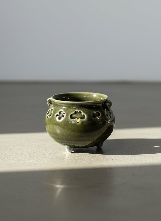dark green ceramic cauldron bowl with shamrock cutout design