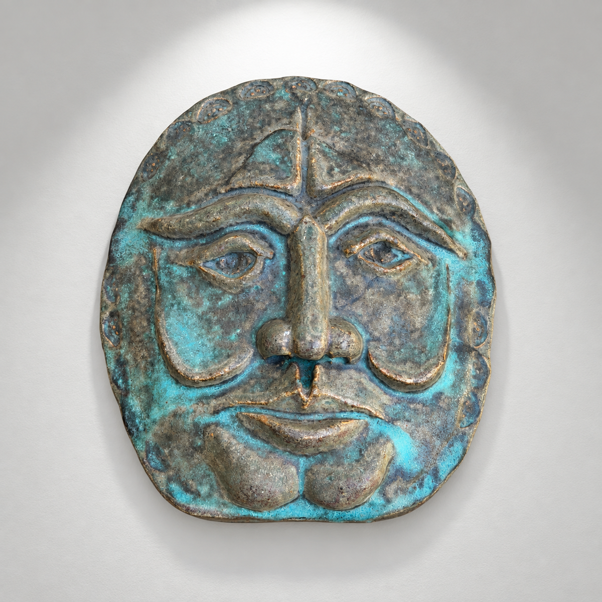 Sculptural face wall plaque with blue-green verdigris finish