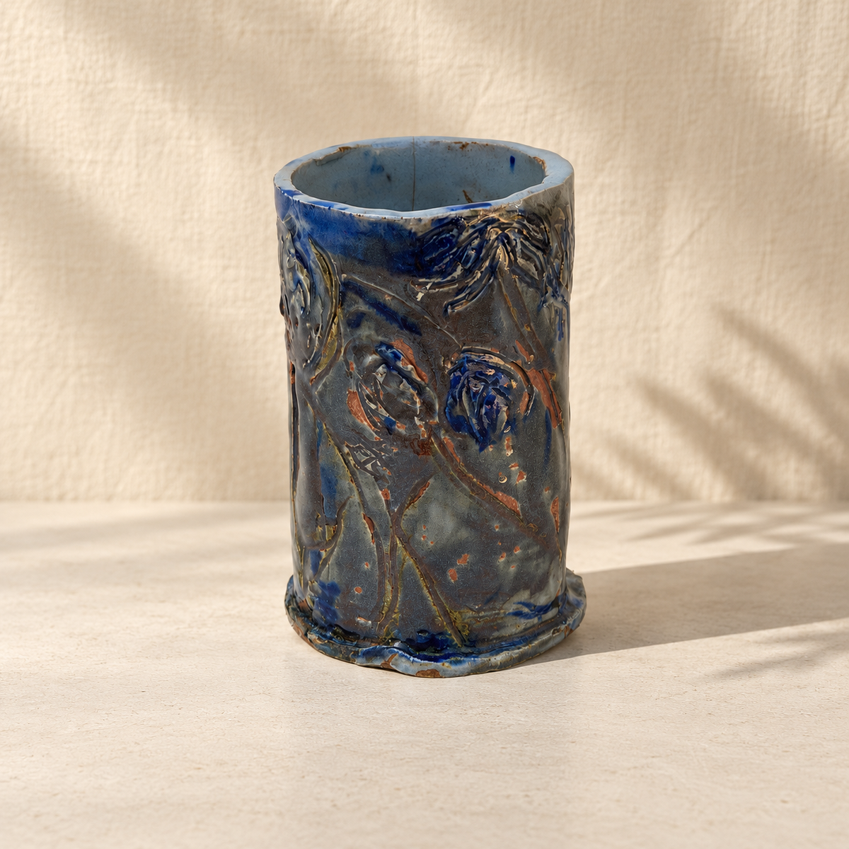 Signed NG studio pottery vase with blue glaze and floral relief