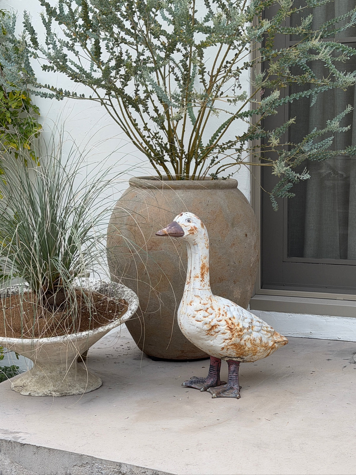 Outdoor goose garden sculpture with distressed painted surface