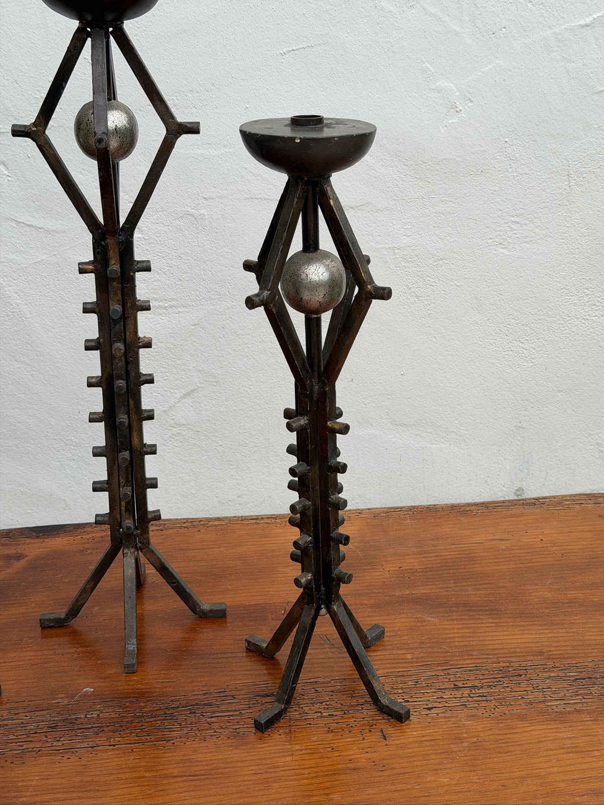 Close-up of orb accent and wrought iron stem on vintage floor candlestick