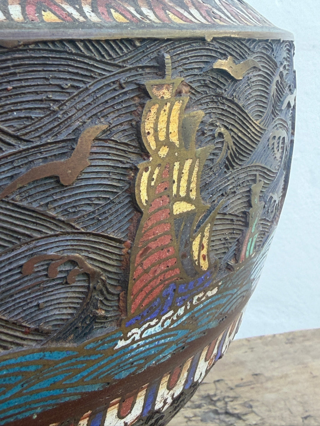 Close-up of ship motif on decorative enamel planter