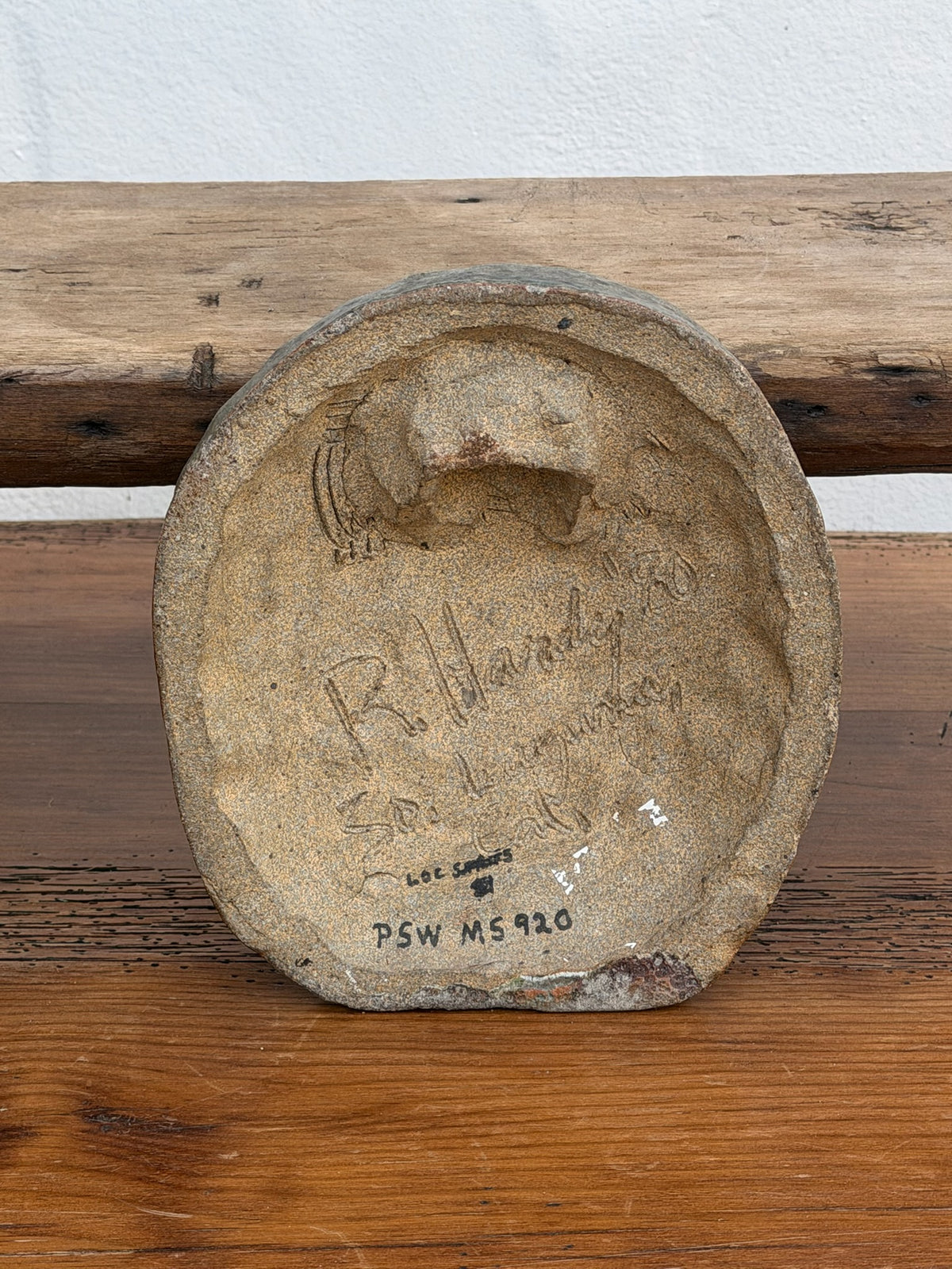 Back of face wall plaque showing R. Hardy signature and 1990 date