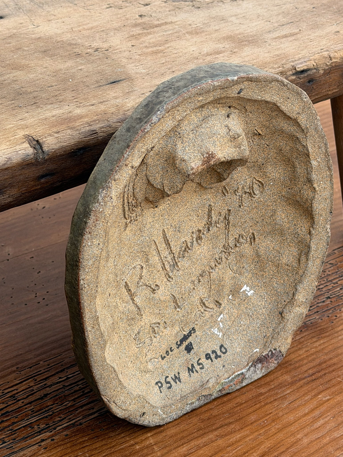 Detail of handwritten R. Hardy signature and date on plaque reverse