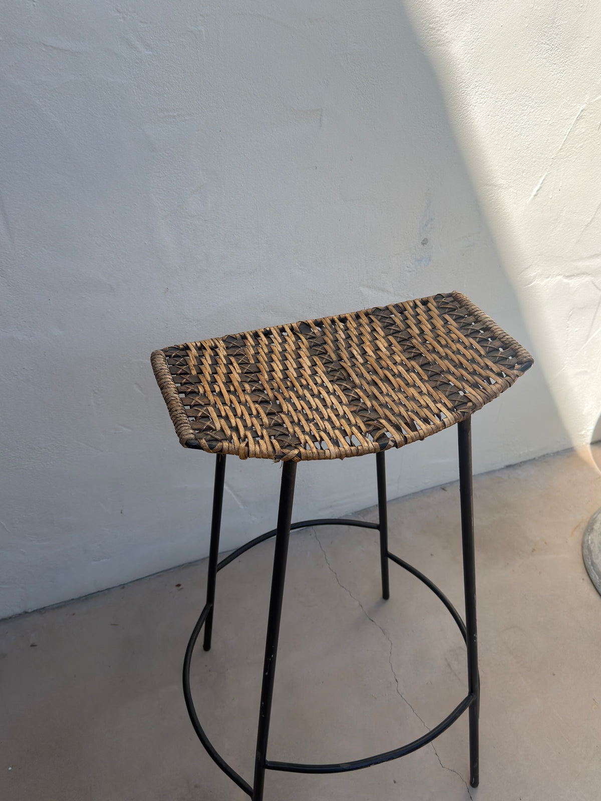 Woven wicker seat on Arthur Umanoff mid-century bar stool