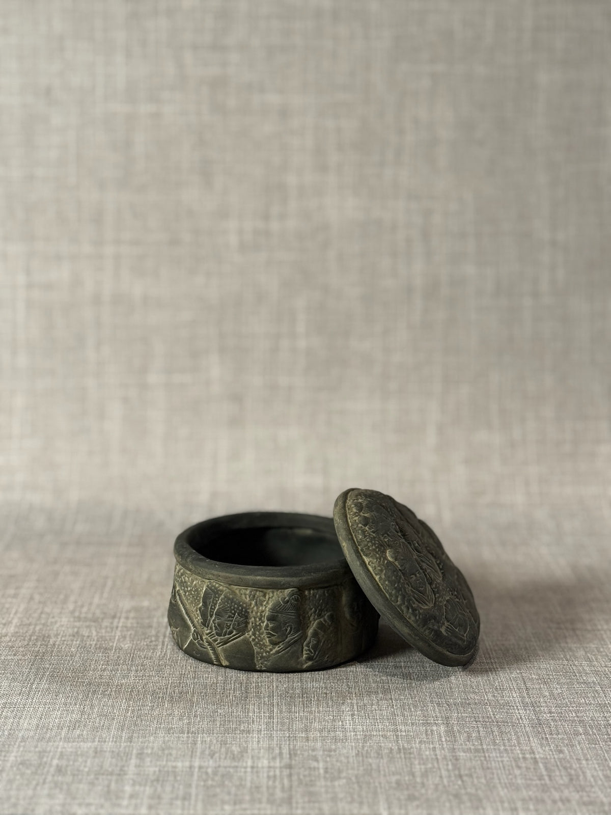 Hand-Carved Dark Grey Terracotta Lidded Vessel with Tribal Portrait Reliefs & Horse Motif