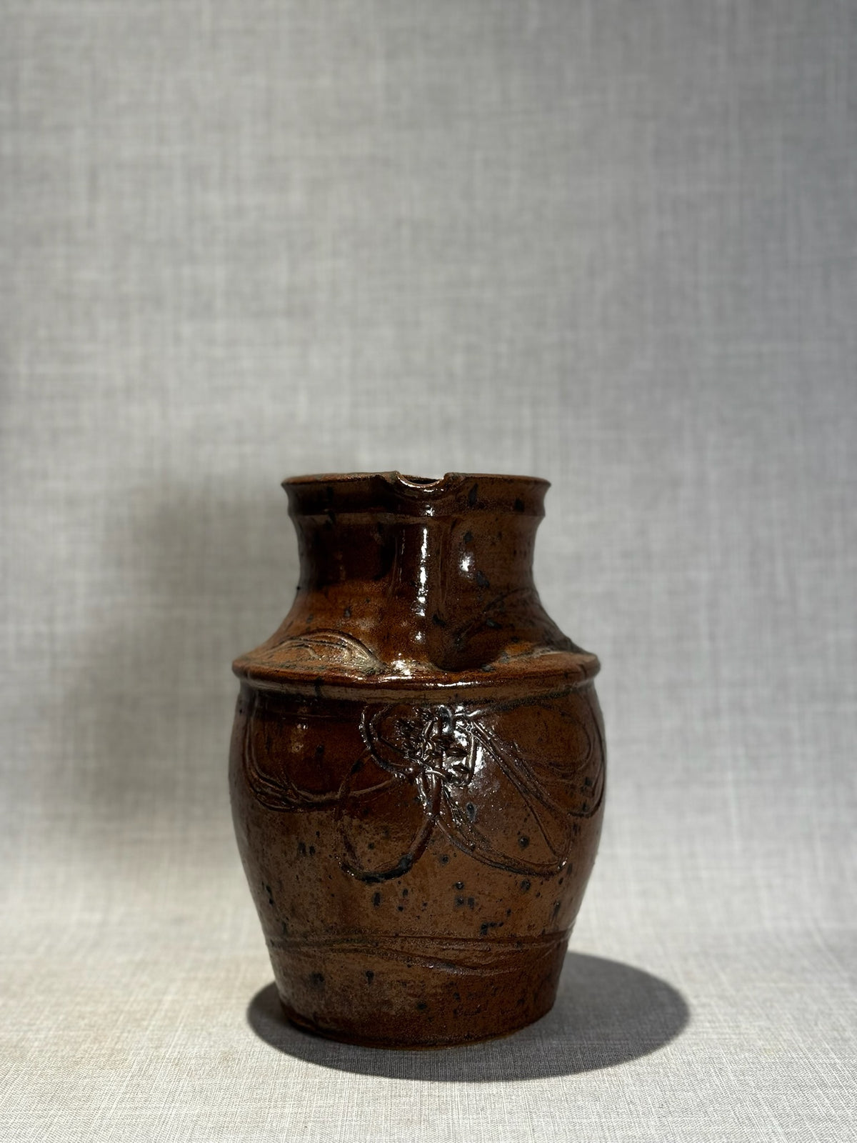 Handmade Rustic Brown Glazed Stoneware Pitcher with Carved Folk Art Motifs