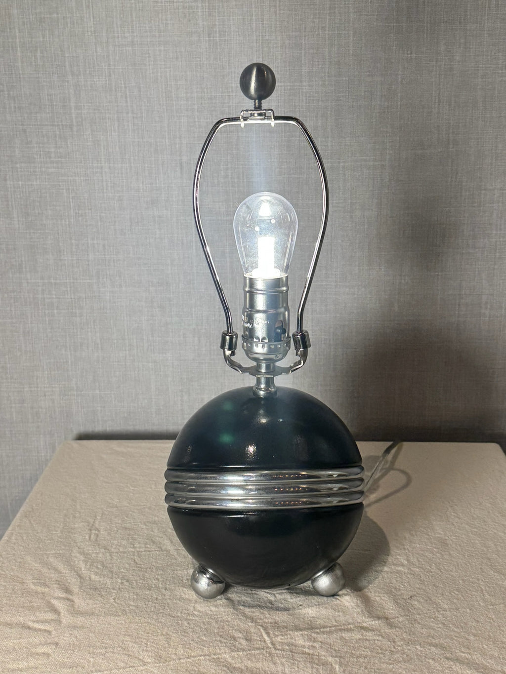 Art Deco Style Black Ceramic Orb Table Lamp with Chrome Banding and Tripod Feet