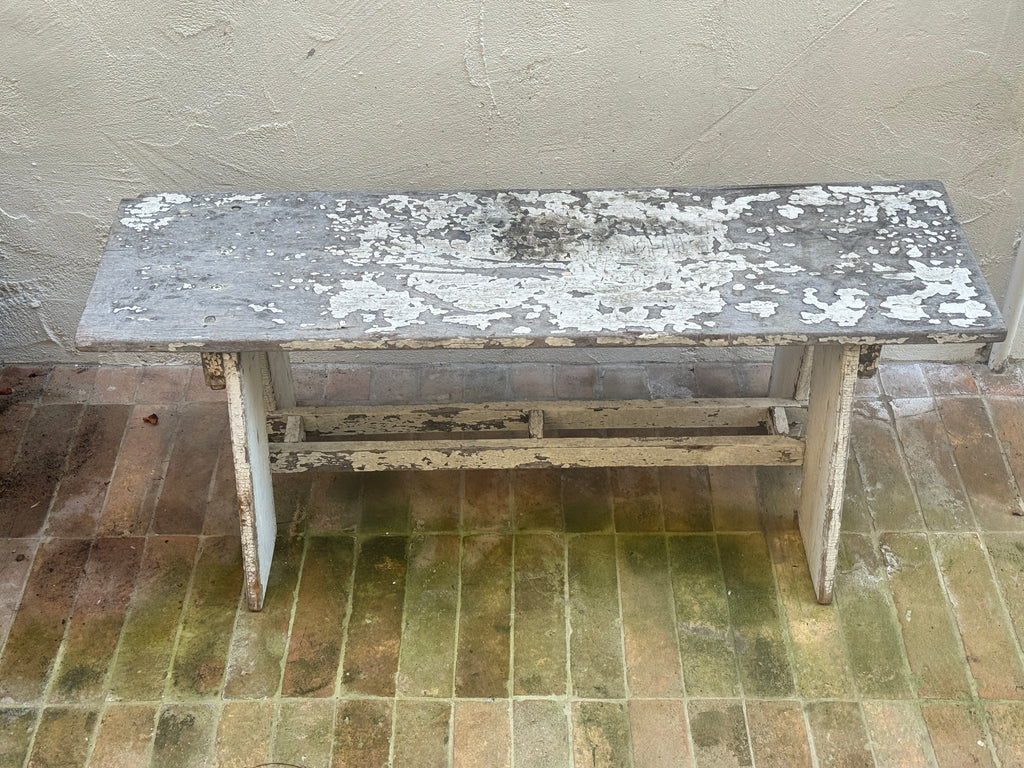 Primitive wood bench with angled slab legs and stretcher base