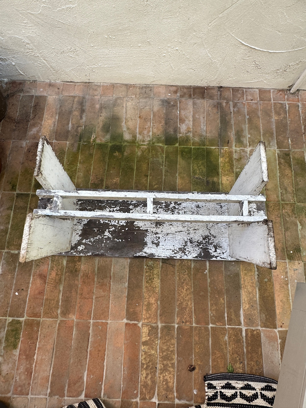 Antique wooden bench with naturally distressed painted surface