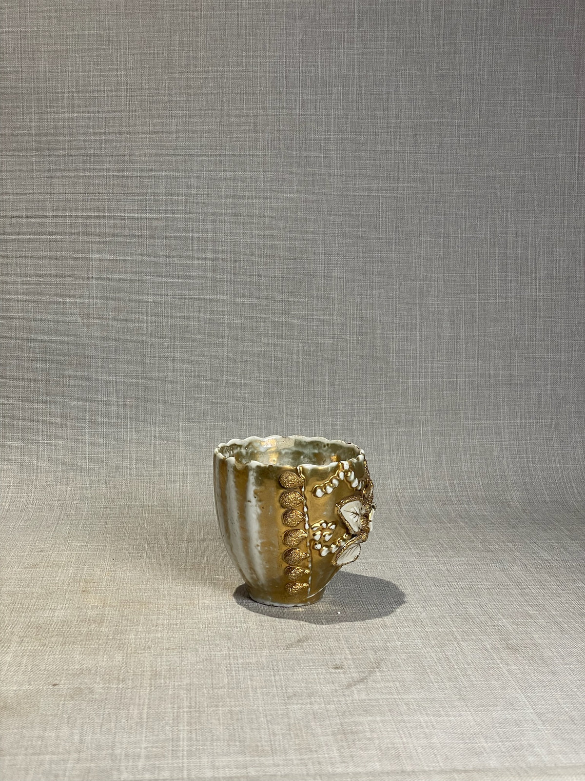 Antique Gilt Porcelain Cup with Applied Floral Medallion