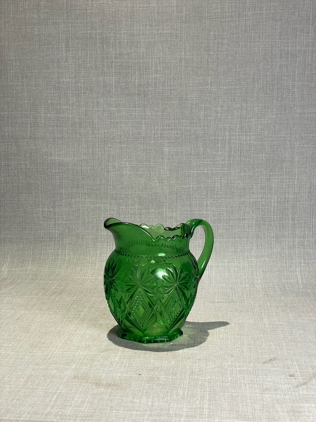Shoshone pattern green glass creamer