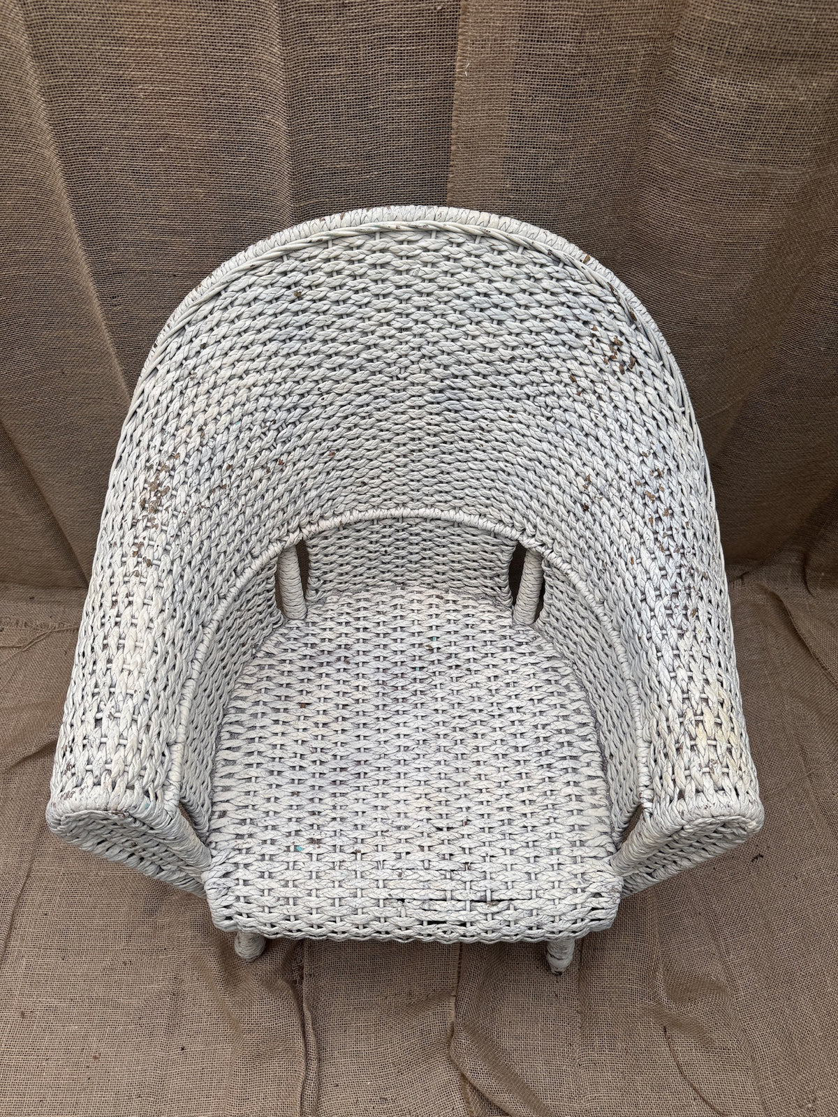Detail of aged white painted finish on wicker furniture