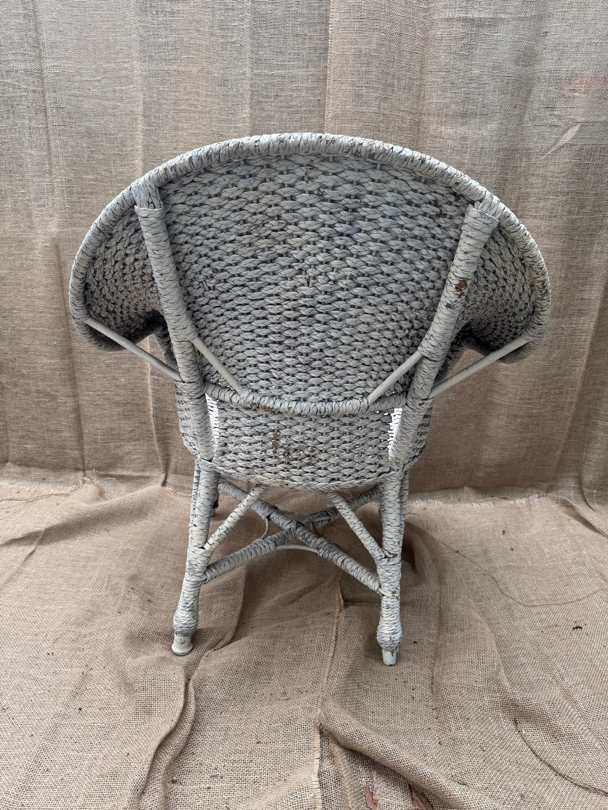 Detail of aged white painted finish on wicker furniture