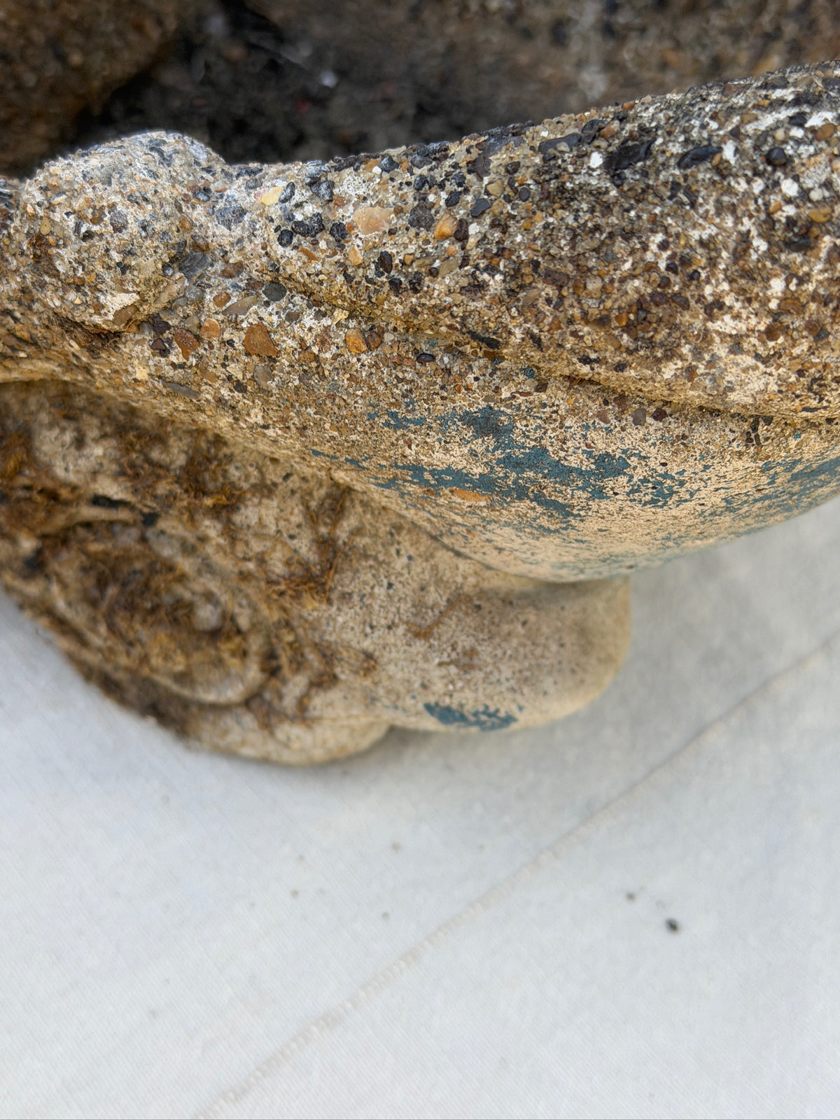 Close-up of weathered pebble-textured concrete surface on vintage garden gnome wheelbarrow planter — Hommes and Gardens, Fauna Collection, Pots + Planters Collection, Home Decor, Landscape Architect, Interior Designer, Outdoor Living, Garden Design, Luxury Design, Art, Objects, Rustic Garden Decor, Nature, Backyard, Yard.