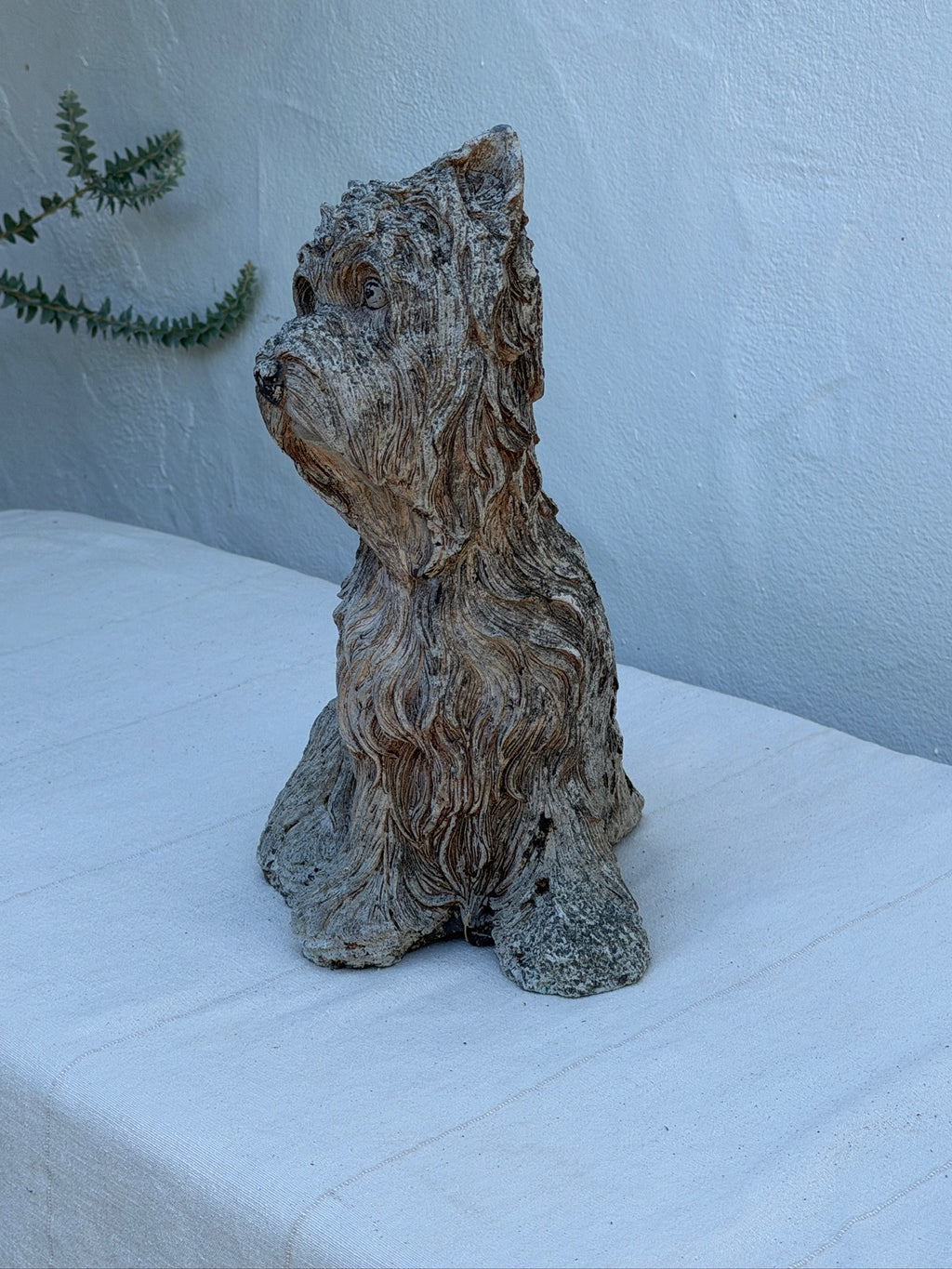 Sculptural terrier garden ornament with detailed textured coat