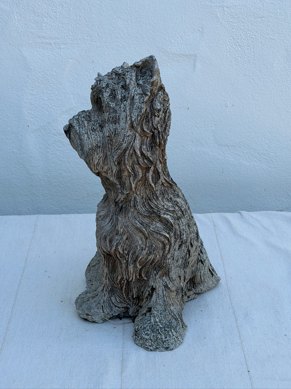 Close-up of textured fur on concrete terrier dog statue