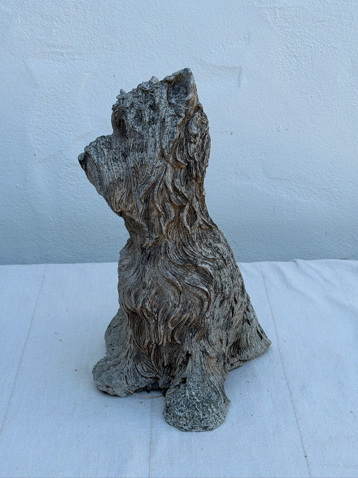 Close-up of textured fur on concrete terrier dog statue