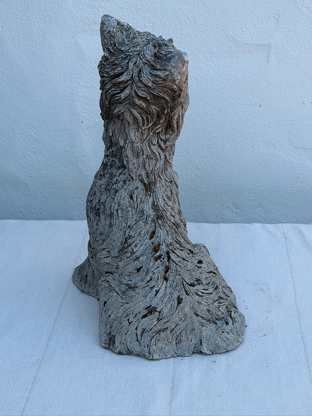 Concrete terrier sculpture with hand-finished textured fur
