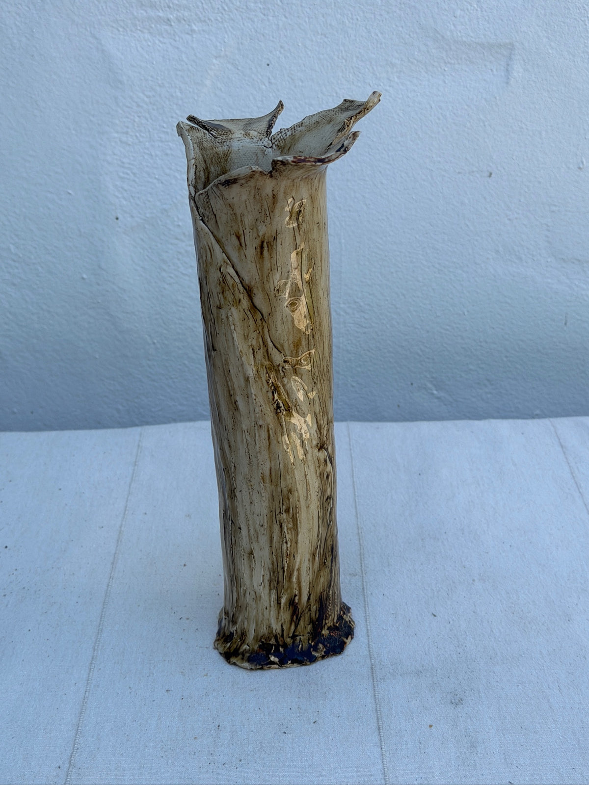 Side view of textured tree-bark ceramic vase