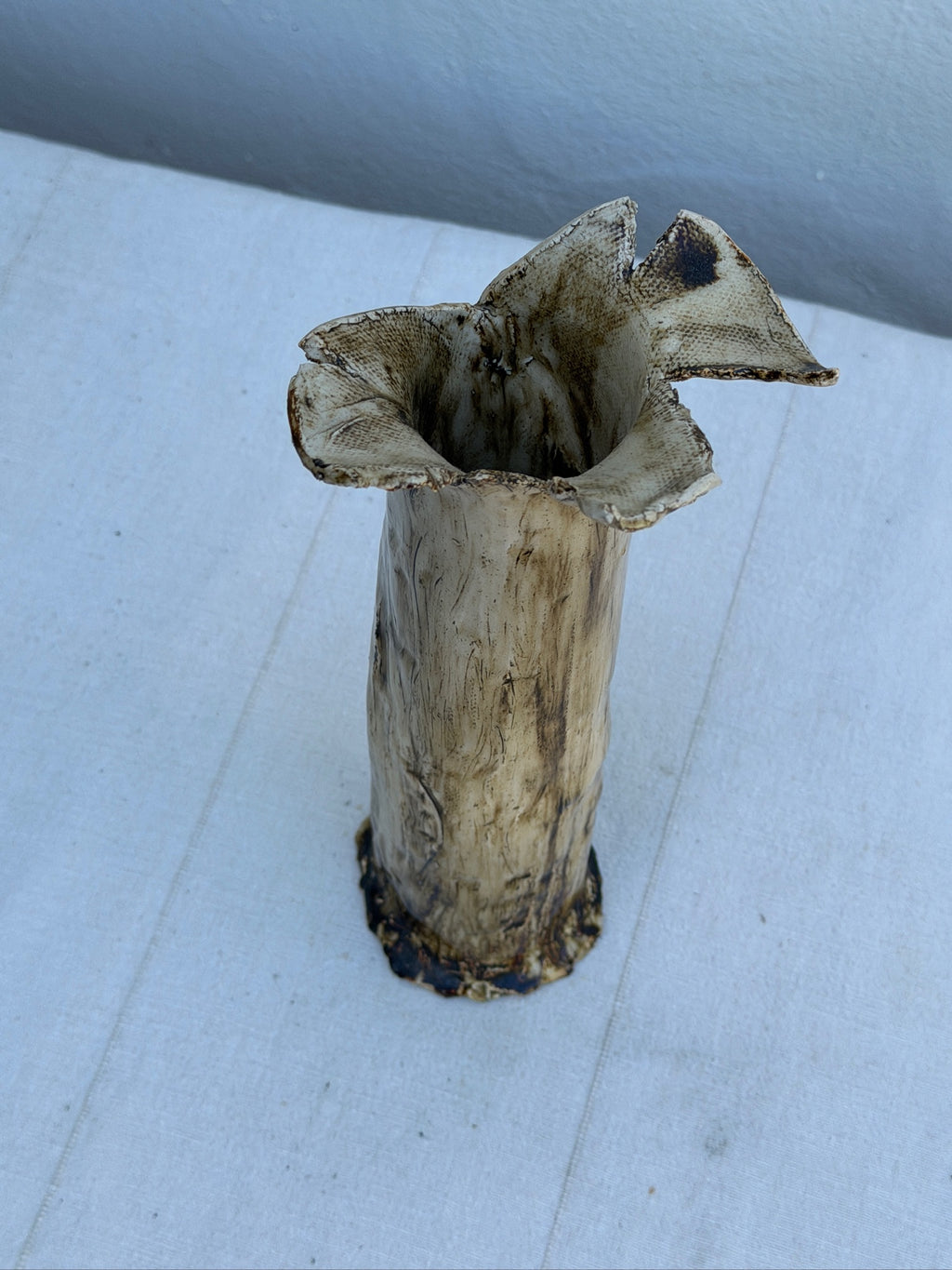 Detail of ruffled rim on sculptural ceramic vase