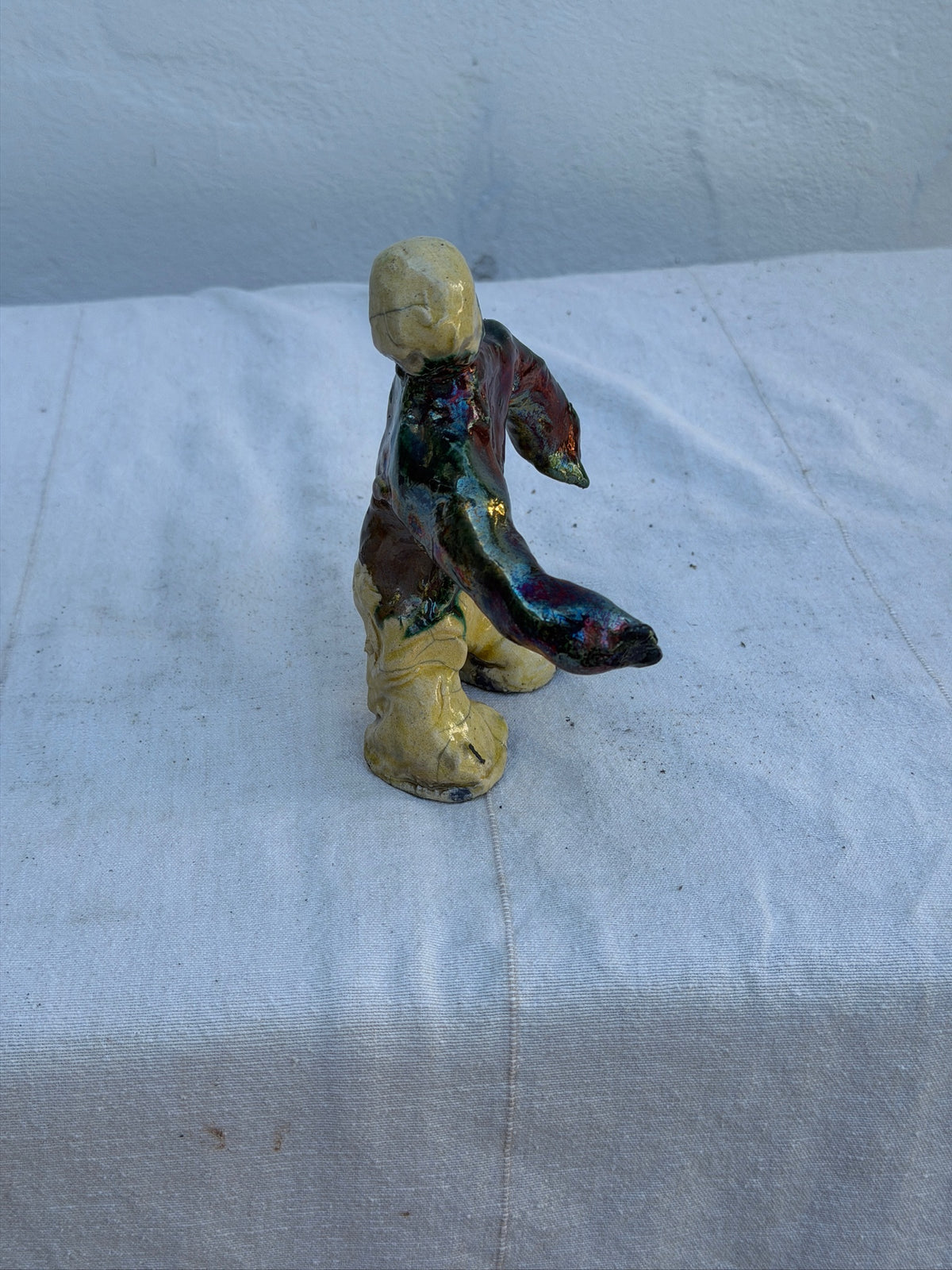 Side view of abstract ceramic studio art figure