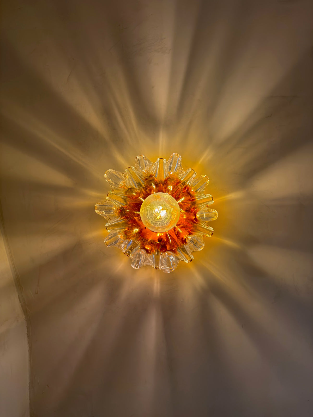 Close-up of textured orange and clear Murano glass on vintage Mazzega wall sconce — Hommes and Gardens, Lights + Lanterns Collection, Home Decor, Interior Designer, Luxury Design, Art, Objects, Italian Design, Murano Glass, Decorative Lighting, Mid-Century Modern, Collectible Design.