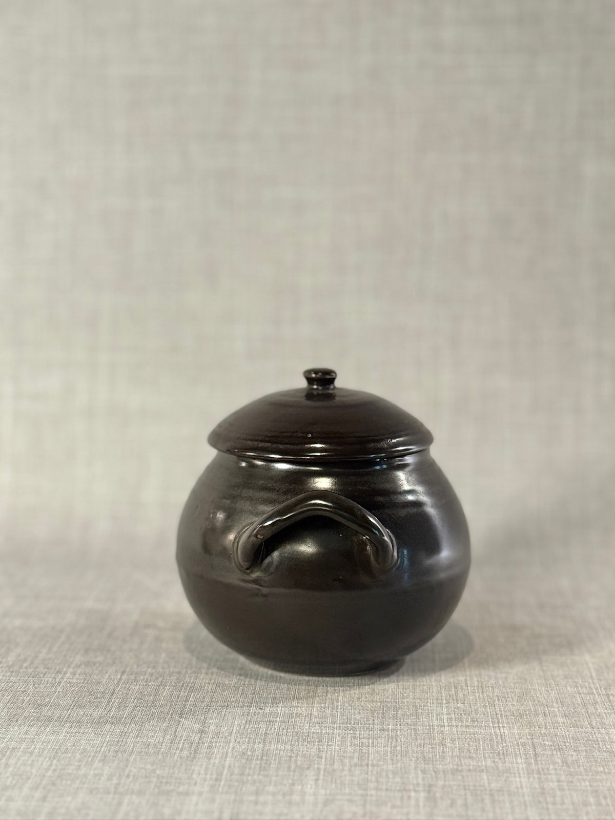 Mid-Century Black Glazed Studio Pottery Bean Pot with Lid and Sculpted Handles