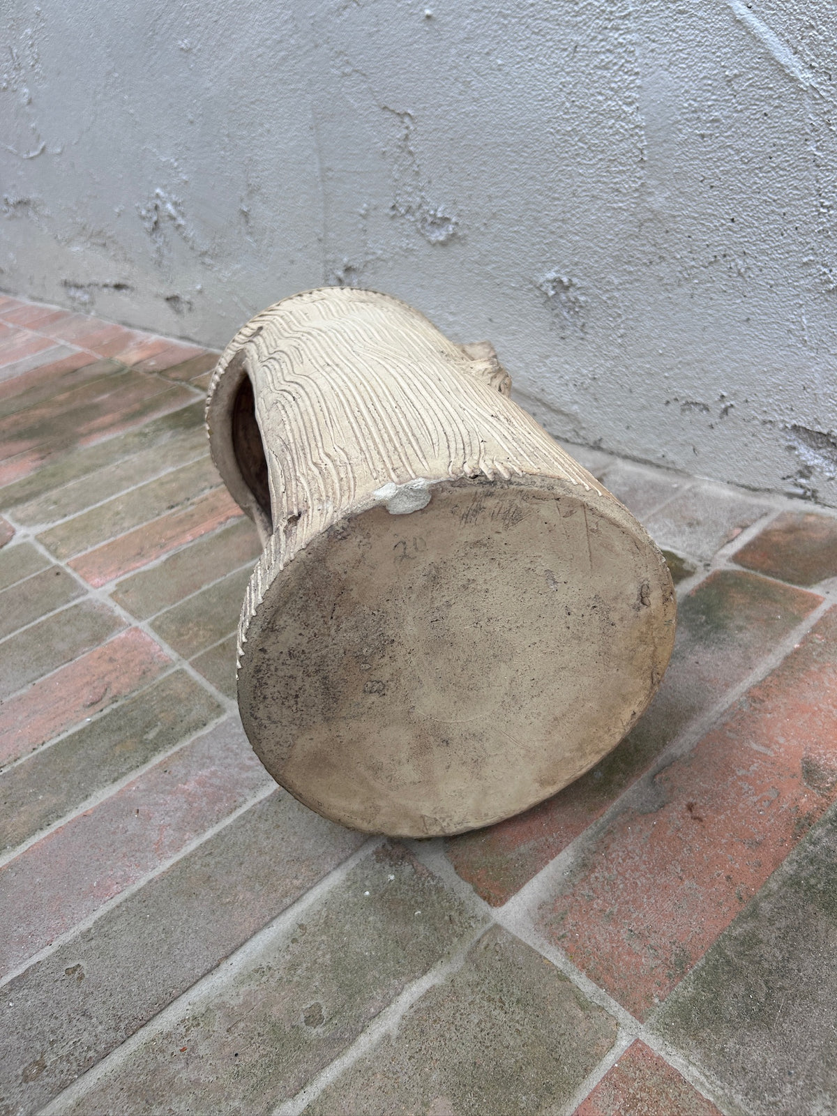 Close-up of bark texture on vintage concrete planter