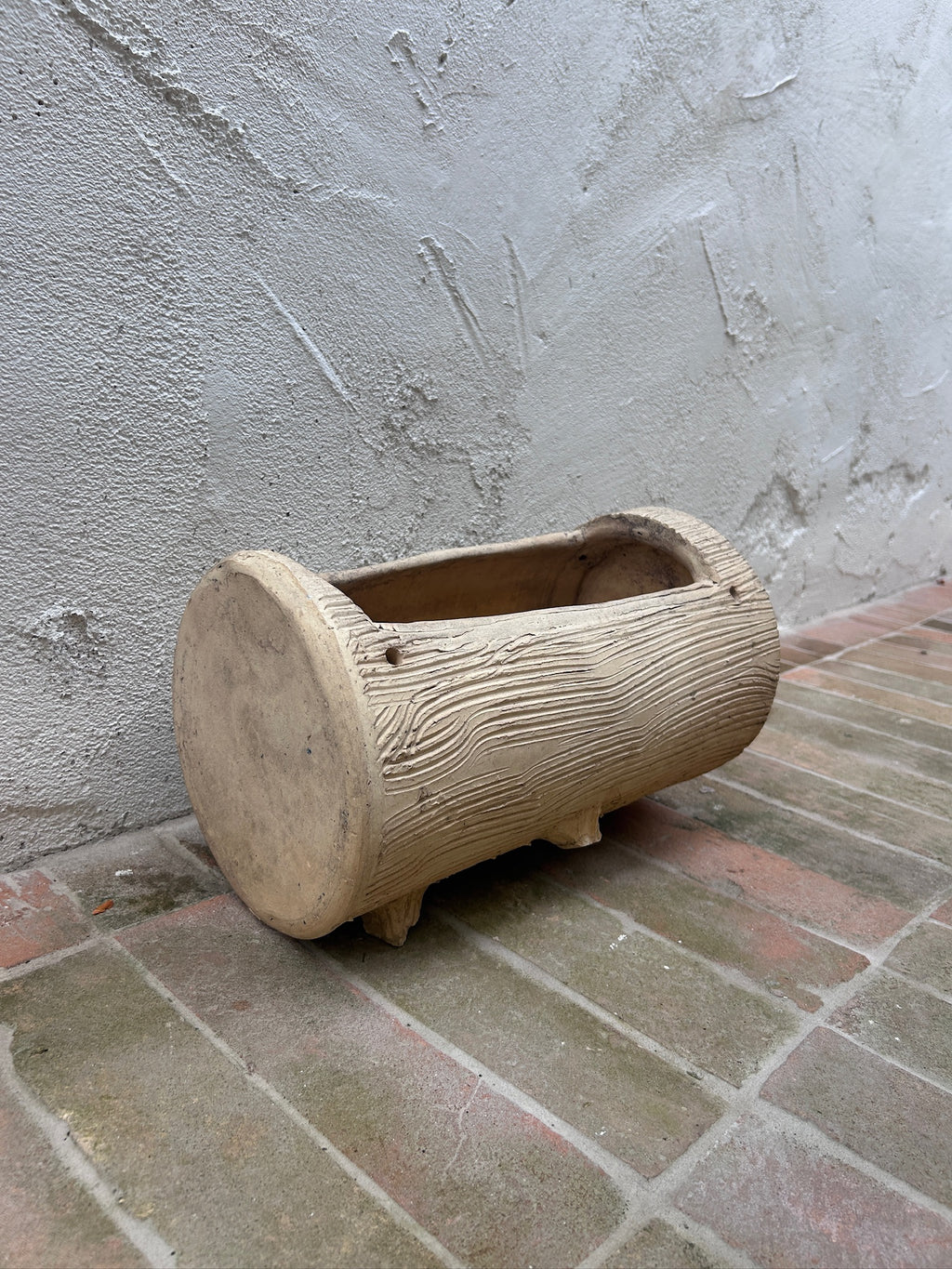 Side view of faux bois log garden planter